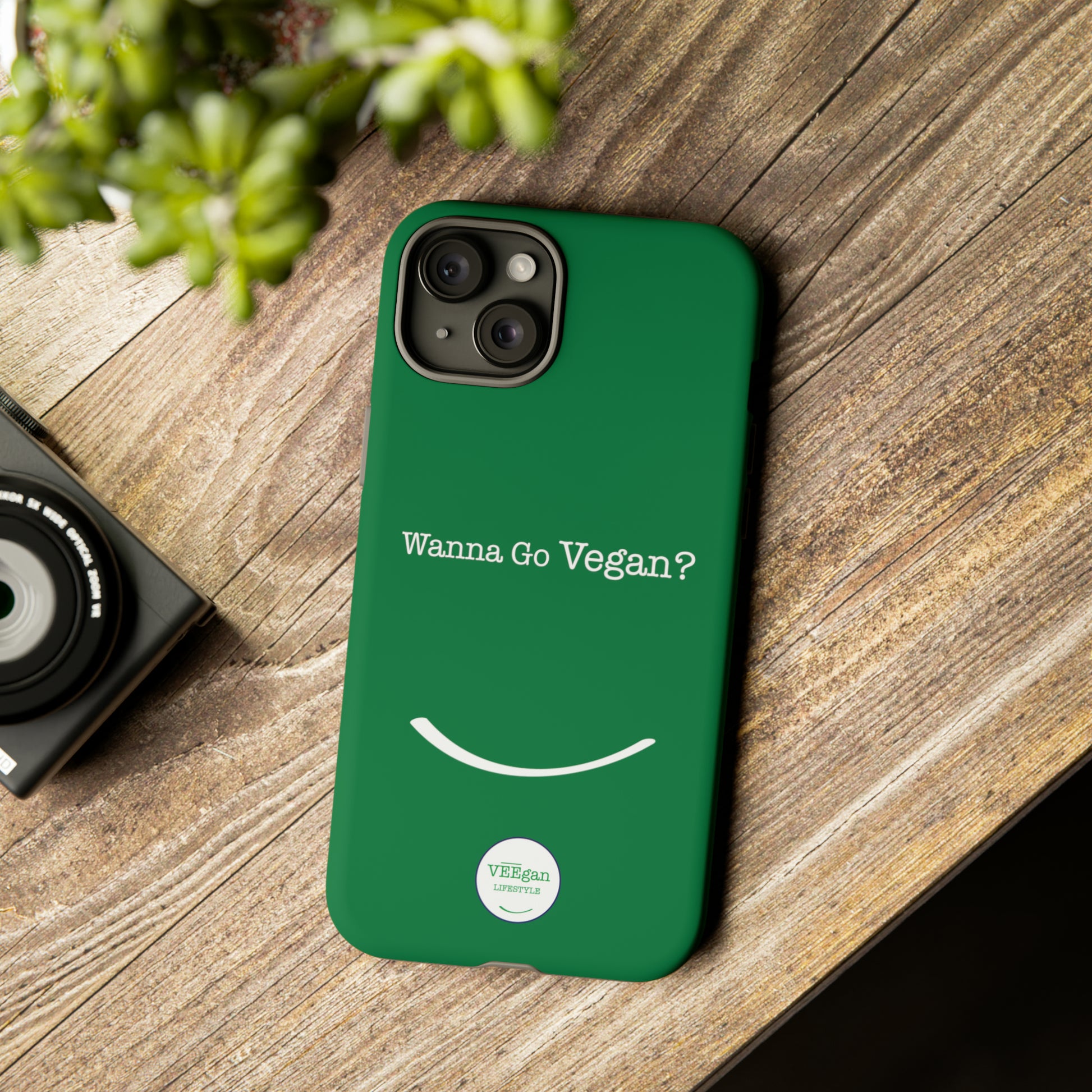 front view "Wanna Go Vegan?" green tough phone case on office desk