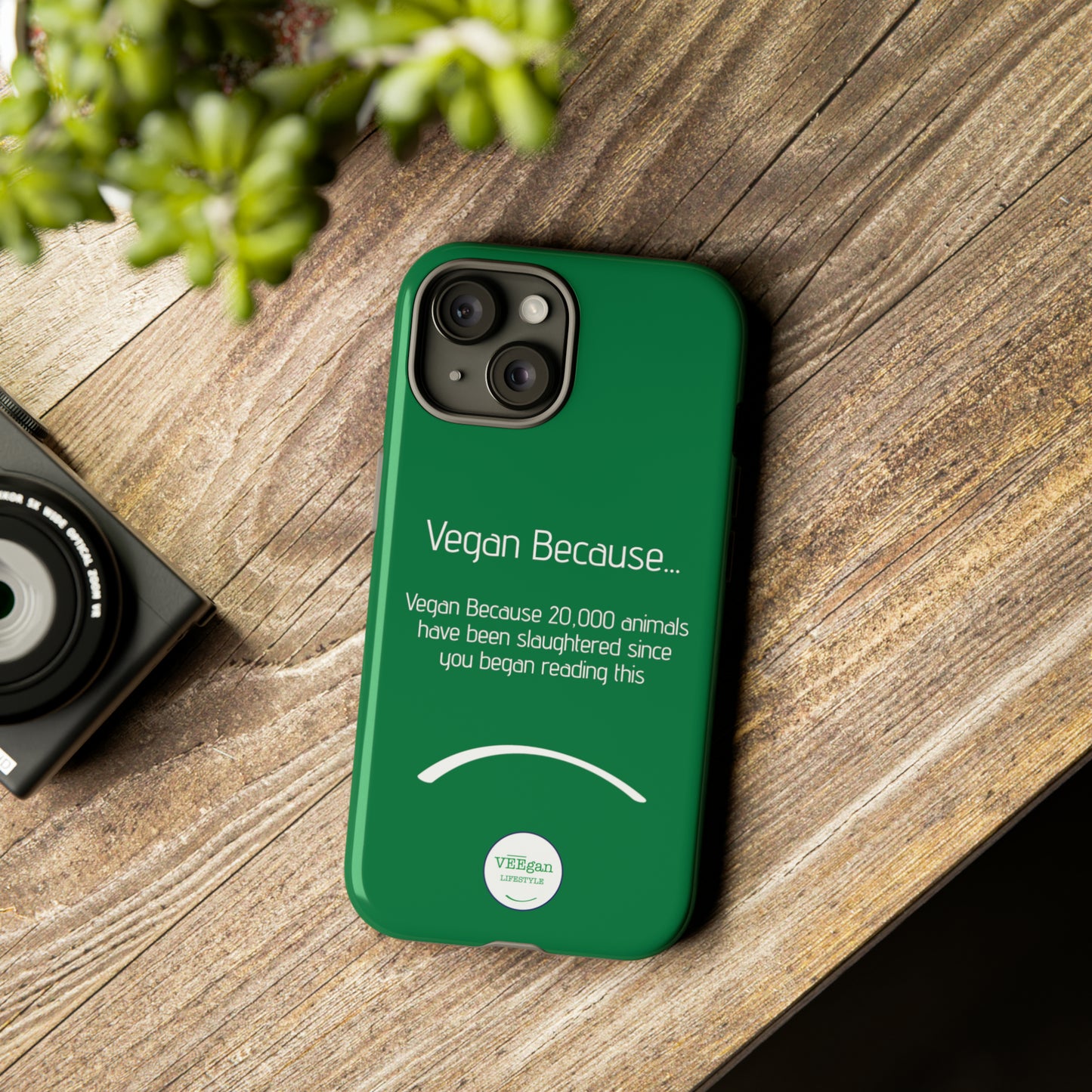 front view "Vegan Because 20,000 animals have been slaughtered since you began reading this" green touch phone case in office environment