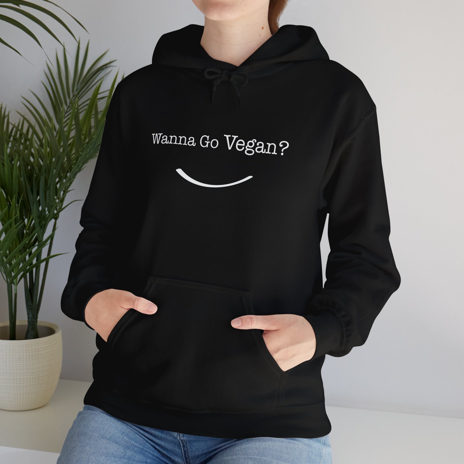 front view "Wanna Go Vegan?" black hoodie in lifestyle background female