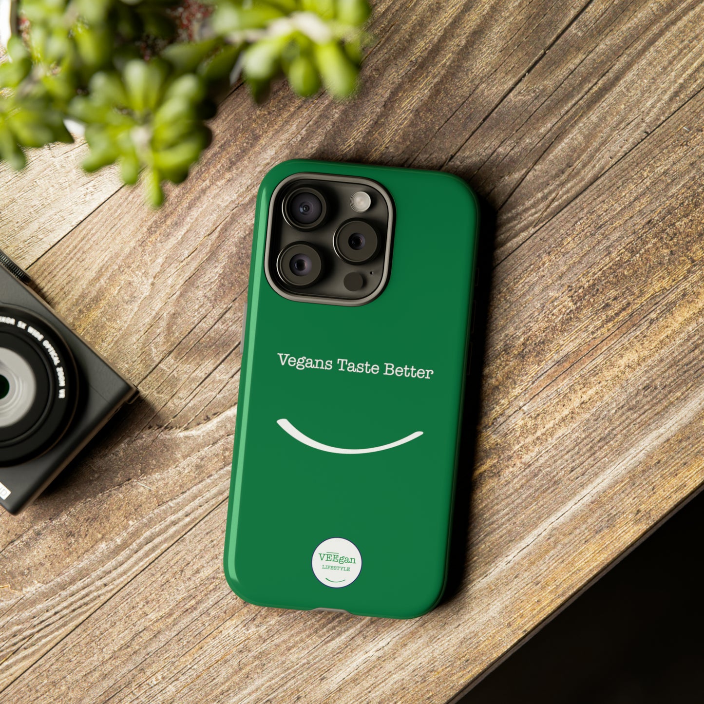 front view "Vegans Taste Better" green tough phone case on office desk