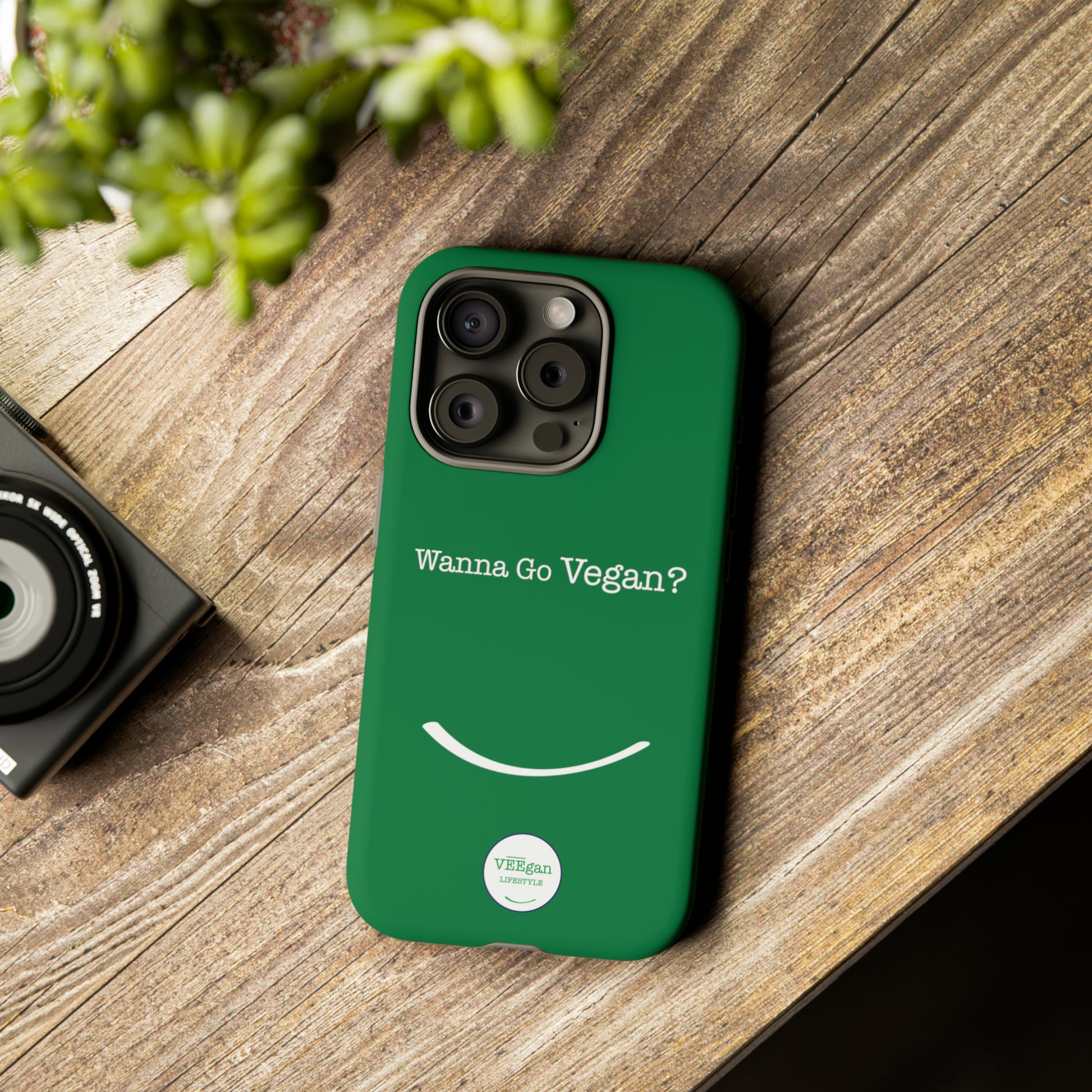 front view "Wanna Go Vegan?" green tough phone case on office desk