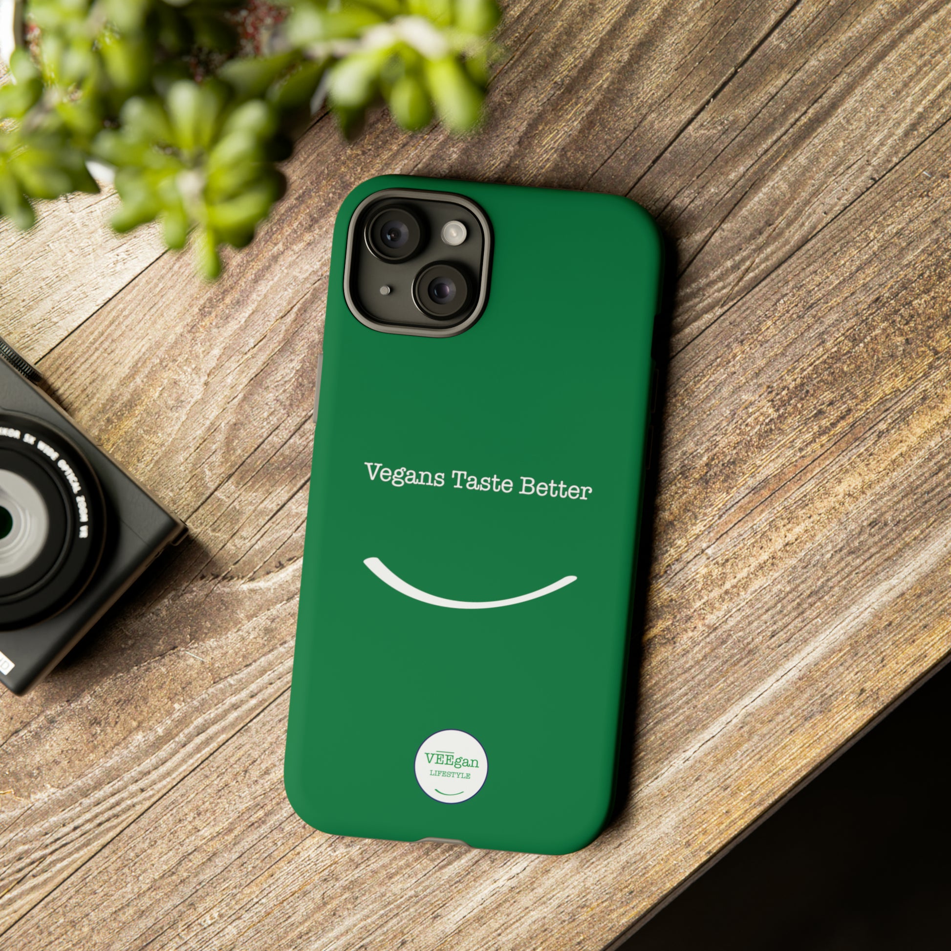 front view "Vegans Taste Better" green tough phone case on office desk