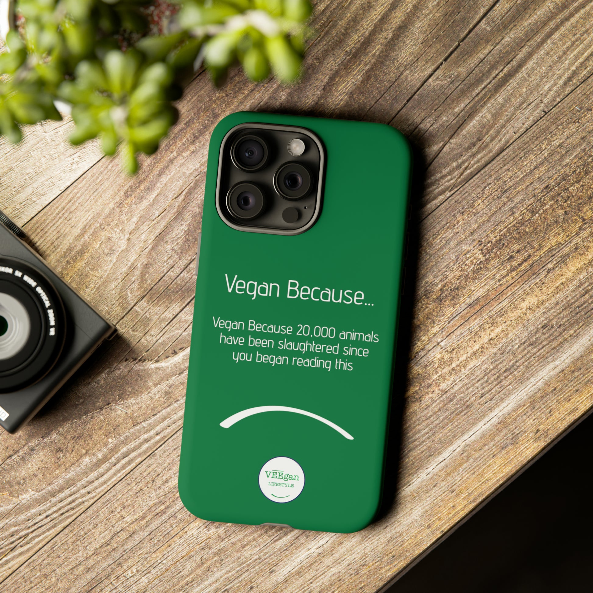 front view "Vegan Because 20,000 animals have been slaughtered since you began reading this" green touch phone case in office environment