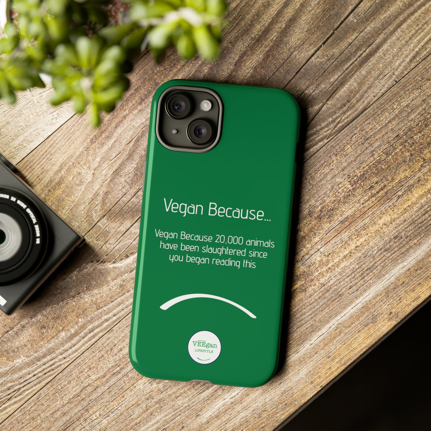 front view "Vegan Because 20,000 animals have been slaughtered since you began reading this" green touch phone case in office environment