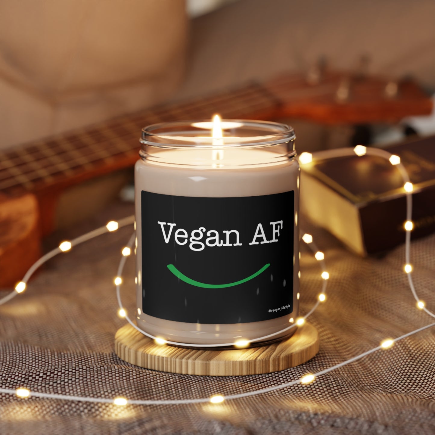 front view "Vegan AF" scented candle with smile in soft environment