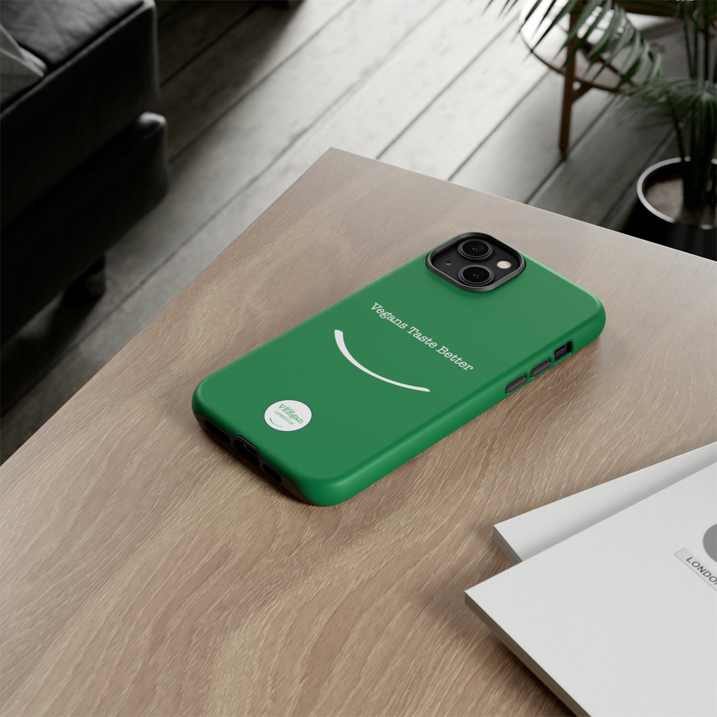 front view "Vegans Taste Better" green tough phone case on office desk