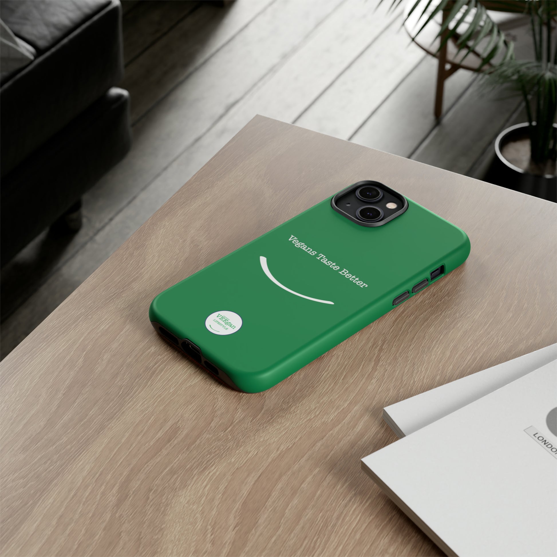 front view "Vegans Taste Better" green tough phone case on office desk