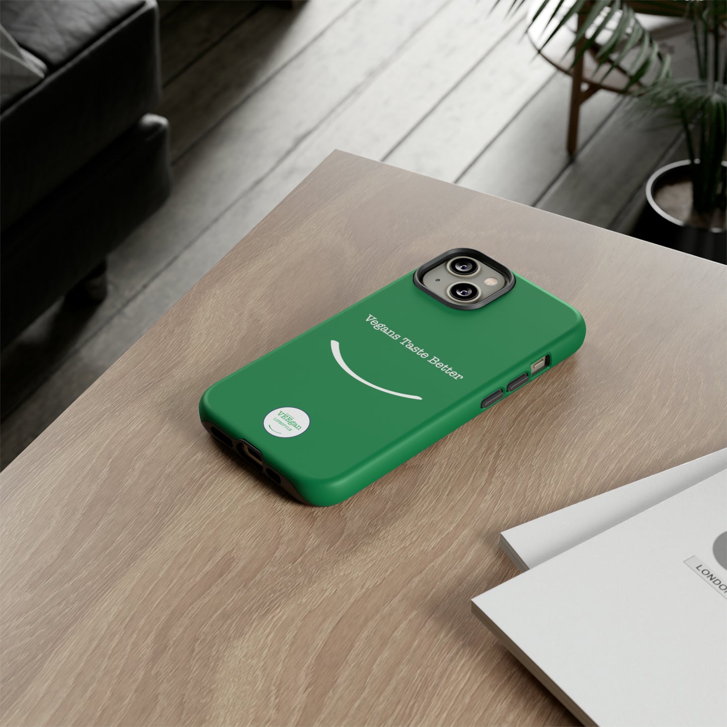 front view "Vegans Taste Better" green tough phone case on office desk